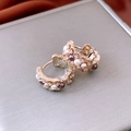 Macro detail of 18K gold plated earrings with vintage pearls and sparkling cubic zirconia - Retro Multi-Color Pearl Gold Hoop Earrings