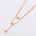 Elegant rose gold double-layered snake chain necklace with three small metal beads - Rose Gold