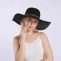 Detail of black lace sun hat showing breathable hollow weave and brown leather cord - Black