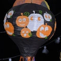 Black 3D paper balloon lantern with pumpkin faces and colorful hanging tassels - Black Pumpkin Hot Air Balloon Lantern