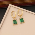 Close-up of square emerald zircon earrings with gold plating on a beige jewelry tray - Emerald Zirconia Gold Earrings (Style 3)