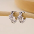 Elegant silver hoop earrings with star-shaped cubic zirconia on a wooden display - Star/Flower Zirconia Embellished Huggie-Silver