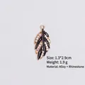 Detail of leaf-shaped alloy pendant with black enamel oil and sparkling rhinestones - Style 4 Leaf / Gold