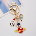 Space themed metal keychain with colorful enamel astronaut and rocket charms on a gold ring - Astronaut Sitting on Ship / Single OPP Bag Packaging
