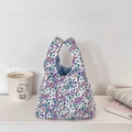 Close-up of floral corduroy wrist bag with blue checkered lining on white background - Light Purple Floral