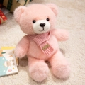 Pink plush teddy bear wearing a knitted scarf sitting on a soft beige rug - Pink Scarf Style