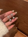 Close-up of snowflake pearl drop earrings with zircon inlays held in hand for detail - Snowflake Pearl Studs / Silver-Grey Pearl