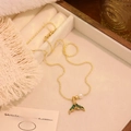 Detail of vintage gold pearl fishtail necklace with green enamel on jewelry box - Green