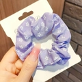 Detail of purple fabric scrunchie with white floral print on a display card - Purple Floral
