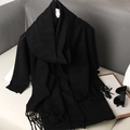 Close-up of soft black cashmere-like scarf showing thick texture and fringe details - Black