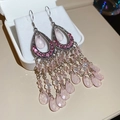 Detail of pink crystal tassel earrings with teardrop gems and bohemian beaded fringe - Hook Style / Pink