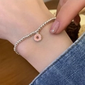 Silver beaded bracelet for women featuring a sweet pink doughnut charm on the wrist - Pink Donut Style (SL0941)