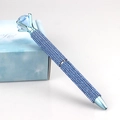 Macro shot of luxury ballpoint pen with blue rhinestones and large top crystal - Sky Blue