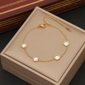 Golden delicate bracelet with four iridescent five-petal flower charms on display box - Purple Flower Style / Gold