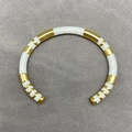 Modern gold and white enamel striped open bangle bracelet for a layered jewelry look - White