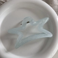 Detailed close-up of a blue star-shaped hair claw clip made of translucent acrylic - Translucent Blue Star