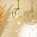 Detail of moon suncatcher with gold butterflies, green vines, and crystal prisms - Red Agate