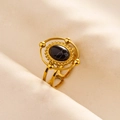 Macro shot of vintage gold ring featuring a black marble stone and hollow double band - Gold Base Black Agate Texture