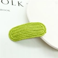 Macro shot of bright green knitted hair clip showing detailed textured weave and fabric - 7# Solid Color Strip Green