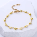Detailed close-up of gold heart charms with blue evil eye enamel on adjustable chain - Yellow Eye
