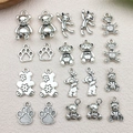 Dettaglio di 20 ciondoli orsetto e zampa in argento antico per creazioni di gioielli - Mix 20 pezzi Serie Orsetti Argento Antico (10 stili x 2)