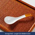 Japanese ceramic soup spoon with orange handle and hanging hole on a wooden tray - Orange Red