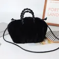 Faux rabbit fur handbag in black with woven top handle and drawstring closure - Black