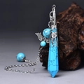 Macro detail of turquoise hexagonal crystal pendant with silver wing chain accessory - Silver Blue Turquoise