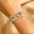 Close-up of silver geometric bangle featuring a hammered texture and rectangular cutout - Silver Geometric Rectangular (8526)