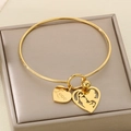 Detail of gold heart charms featuring mother and child silhouette with Love engraving - Love and Mother-Child Hollow Heart Style (KB96748-Z)