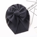 Detail of baby turban hat in dark grey waffle knit fabric with a large bow decoration - Dark Gray