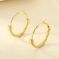 Detailed close-up of gold stainless steel hoop earrings with unique ribbed texture and clasp - Dense Horizontal Thread Design (KE119458-LO)