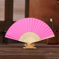 Pink DIY paper folding fan with hollow wooden ribs and matching stand on a desk - Rose Red