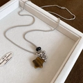 Detailed shot of star-shaped tiger eye stone pendant with silver fringe on snake chain - Star Style