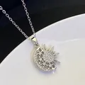 Macro detail of sun and moon pendant with shimmering zircons on silver stainless steel - Silver (8302)