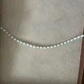 Detail of bow seed bead necklace with white shuttle beads and turquoise accents - White Oval Beads Style