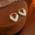 Macro detail of heart-shaped gold-plated pearl hoop earrings on velvet display - Gold Off-White Heart Ear Clip (6#)