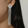 Elegant silver heart-shaped tassel earrings with pavé rhinestones on model side profile - Silver Heart Pave Rhinestone Long Tassel Style (DTE1616907S)
