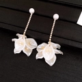 Macro detail of cascading floral earrings with white pearls and sparkling rhinestones - Gold-White (Style 27)