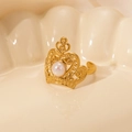 Macro shot of gold crown ring featuring a lustrous pearl inlay and hollow carvings - White Pearl-Gold