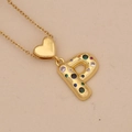 Detail of a gold letter P pendant featuring colorful zircon stones and heart charm - Letter P / Gold