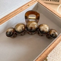 Detailed view of amber tortoise shell hair claw clip with five resin beads in a wooden box - Amber Bead Hair Claw / Dark Coffee