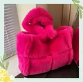 Detailed view of the rose red faux fur tote bag with quilted pattern and soft wide handle - Rose Red