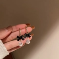 Close-up of vintage black bow earrings with faceted crystal drops in warm light - Black Bowknot Transparent Crystal Ball Style (147#)