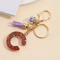 Colorful resin letter C keychain with mixed glitter, purple tassel and golden rings - Letter C