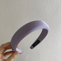 Handmade thick purple wide headband in matte fabric shown held by hand against a wall - Purple