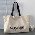 Minimalist cream canvas tote bag with black voyage lettering and sturdy black handles - Large Capacity Letter Style / Voyage Beige