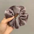 Close-up of oversized dusty purple satin scrunchie with elegant ruffled edges and soft luster - Grey Purple