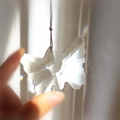 Hand holding a crystal butterfly suncatcher prism with light refraction and red string - 7*5cm / Butterfly Transparent