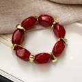 Bracciale in acrilico con perline di resina rossa glitterata e distanziatori dorati - Bracciale-Rosso